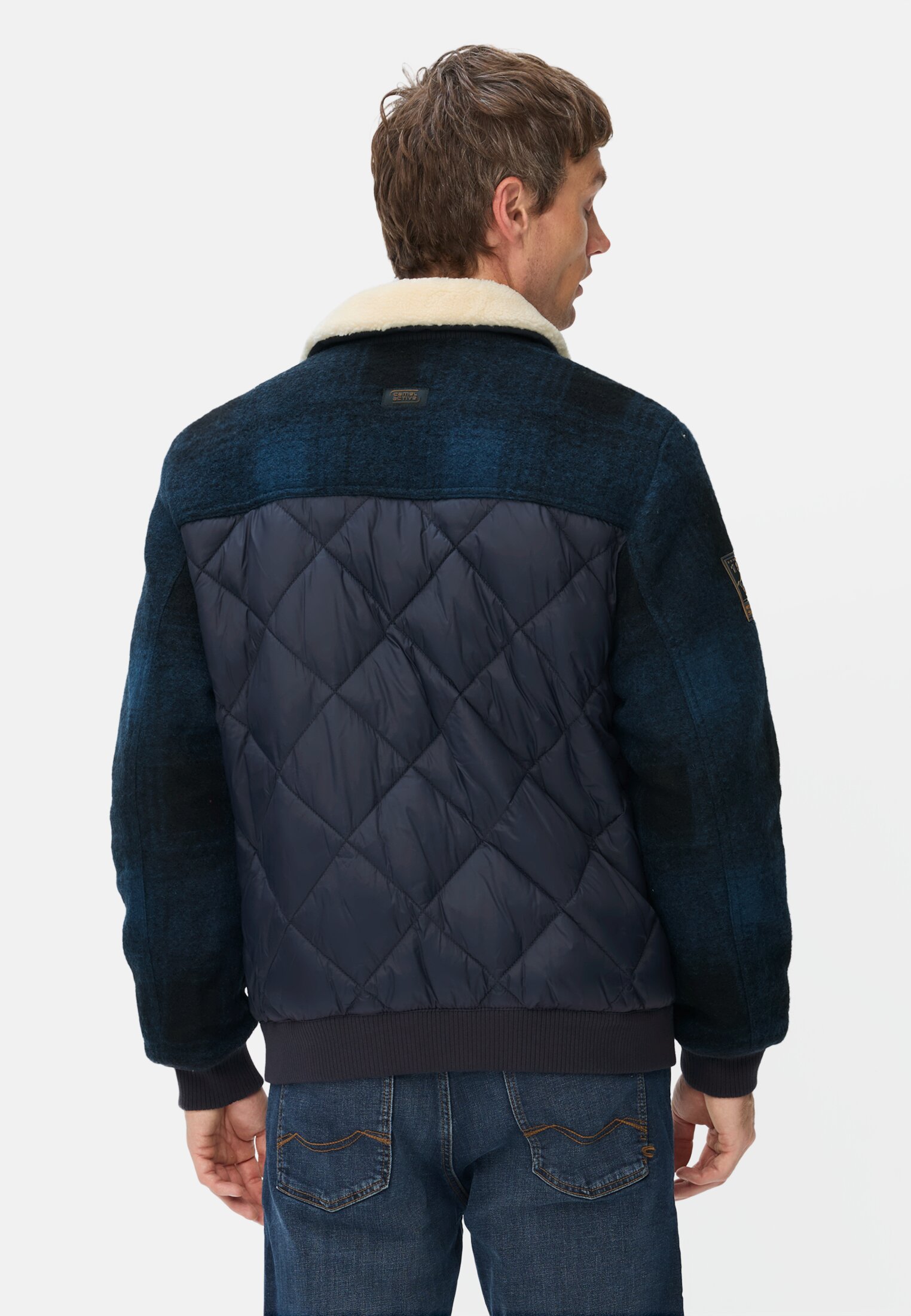 Men Bomber jacket with quilted pattern on the back tinted blue worn back