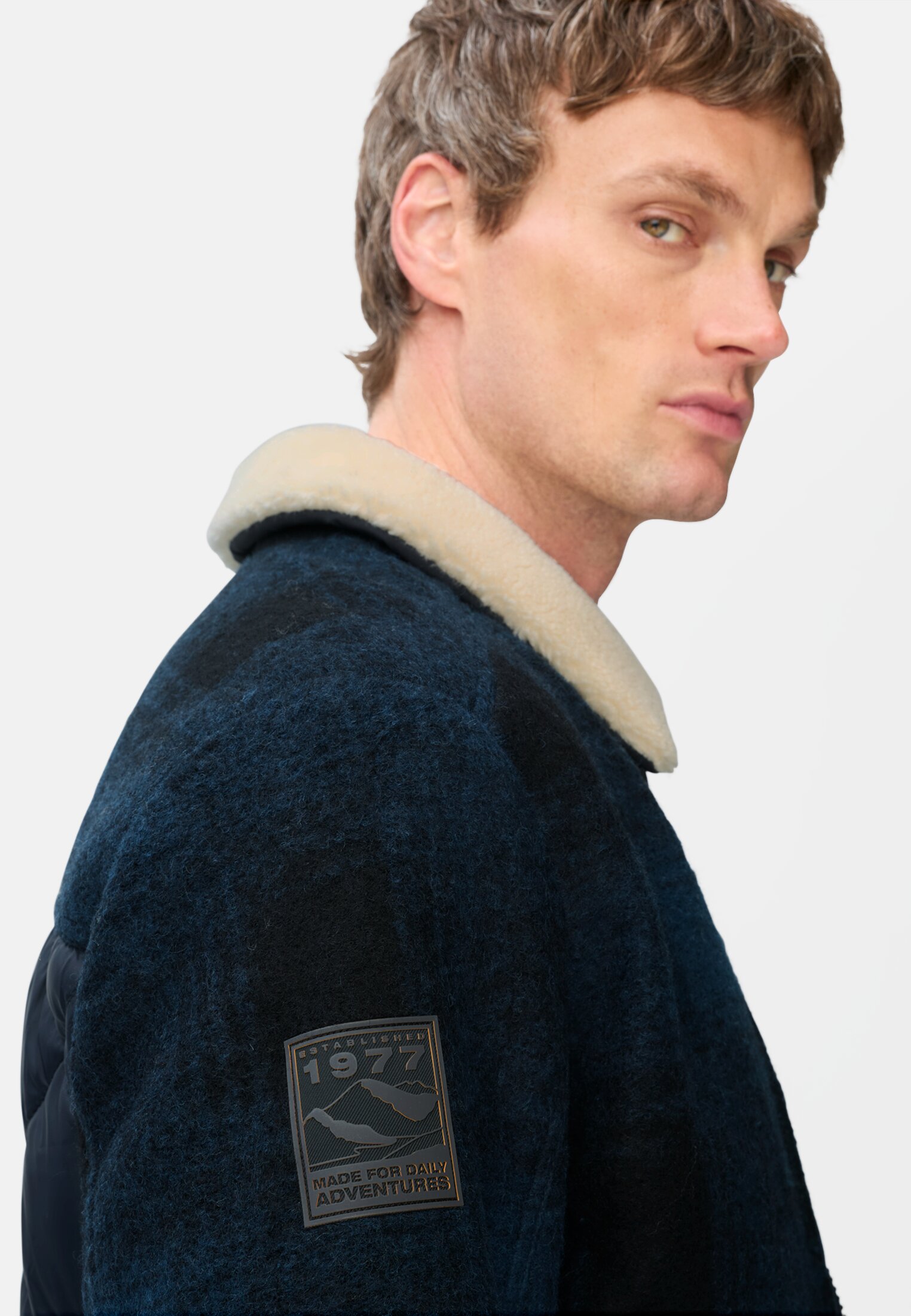 Men Bomber jacket with quilted pattern on the back tinted blue worn detail close